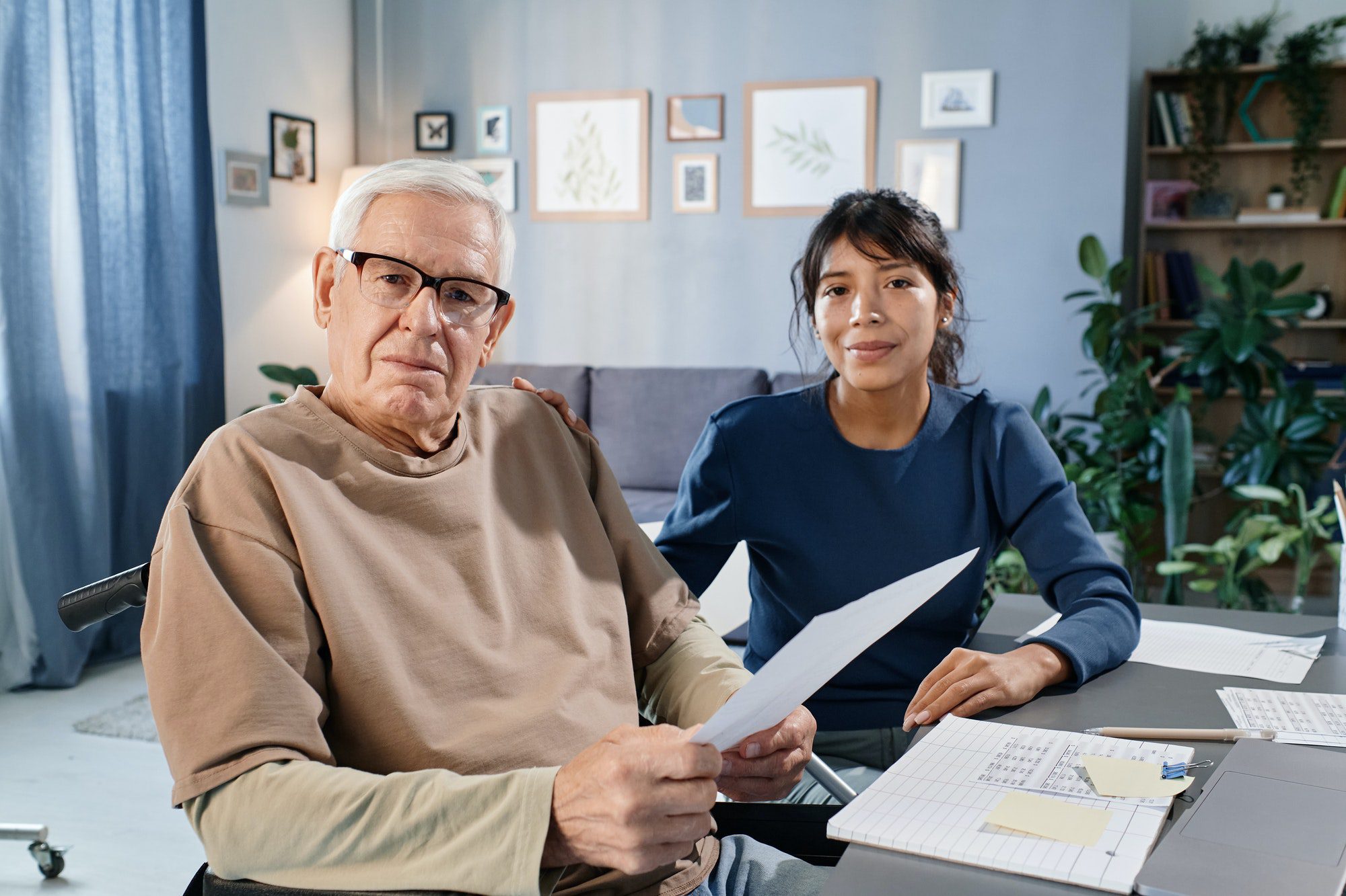 Seniors man discussing his medicare taxes with an assistant.
