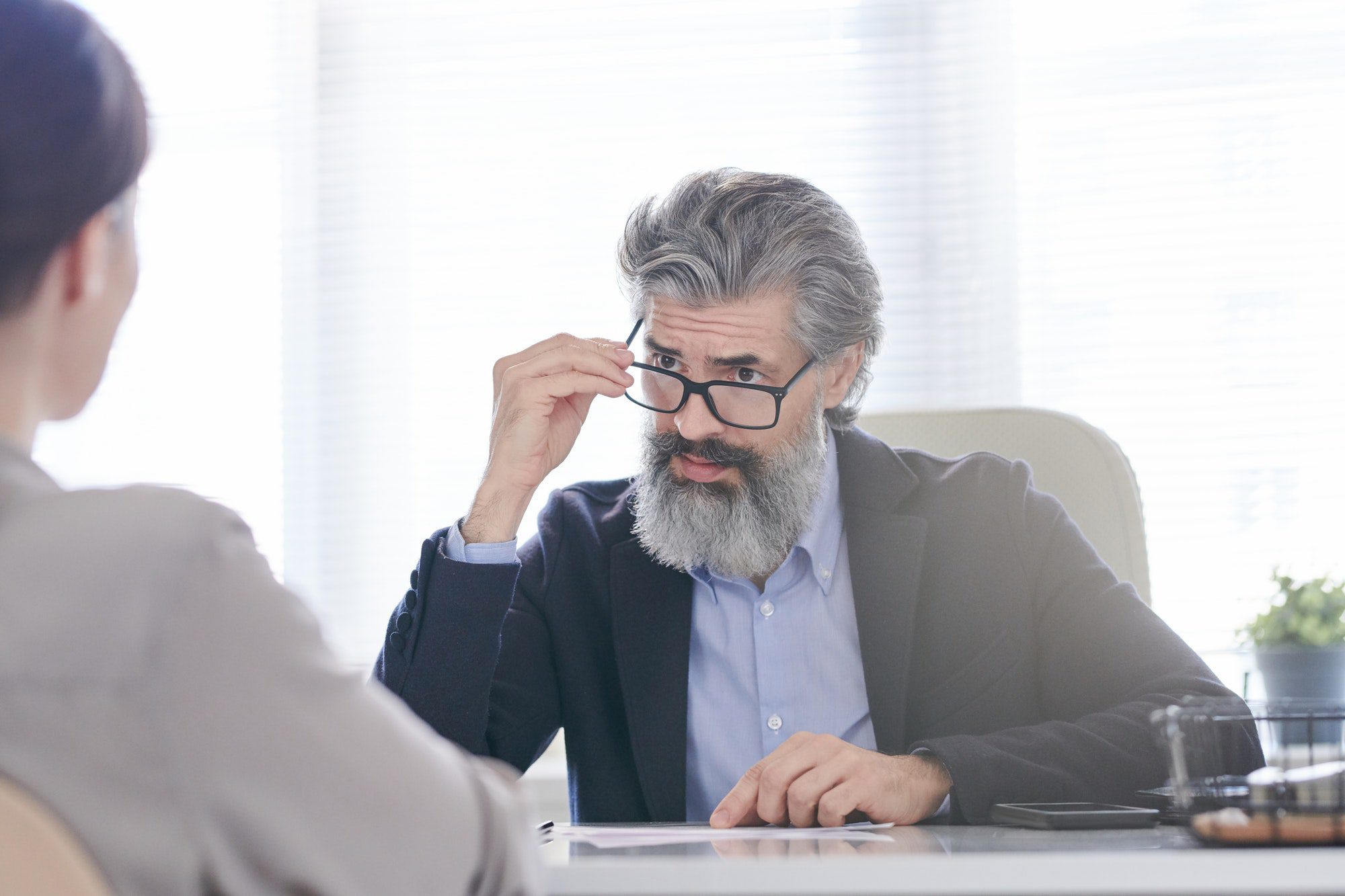 Curious senior business man asking questions about plan G coverage.
